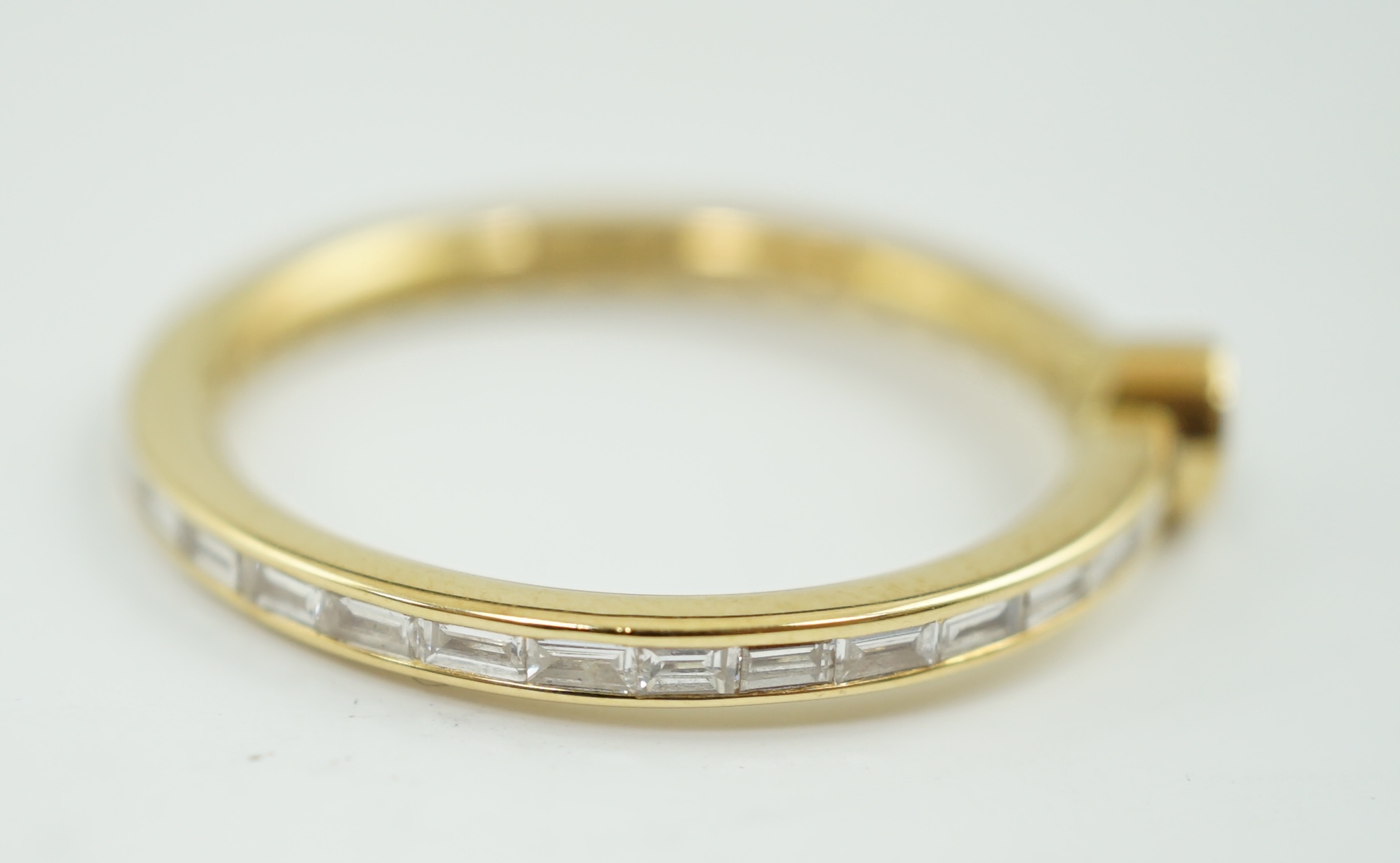 A modern 18ct gold, round and baguette cut diamond set ring